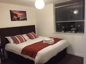 Giường trong phòng chung tại Stratford Luxury Apartments