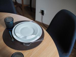 a plate on a table with a black chair at 12 Casa d'Avó in Albergaria-a-Velha
