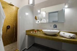 a bathroom with a sink and a mirror at Pancratium Villas & Suites in Akrotiri +50 photos