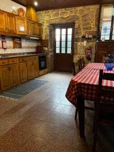 a kitchen with a table with a table cloth on it at Casa da Venda in Covide