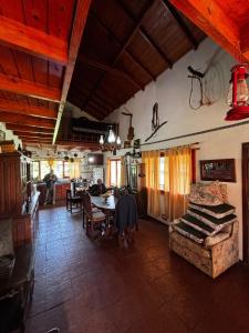 a living room with a table and a couch in a room at Casa de campo - Paraiso Natural en Laguna de los Padres in Sierra de los Padres