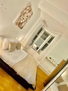 a bedroom with a bed and a large window at Cozy Studio Apartment in Leeds