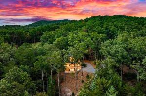 an aerial view of a house in the middle of a forest at sugar mountain lodge in Blue Ridge