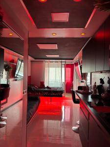 a living room with red lighting and a couch at C12 Deluxe in Cap d'Agde