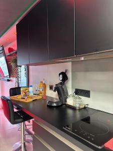 a kitchen with a black counter top and black cabinets at C12 Deluxe in Cap d'Agde