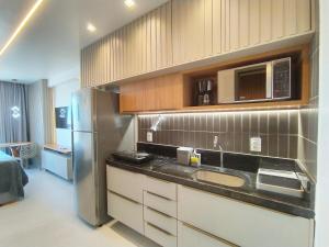 a kitchen with a sink and a refrigerator at Studio Manaíra #SSR802 Prox Shop in João Pessoa