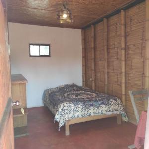 a bedroom with a bed in a room with a window at Wasi Center Homestay in Máncora