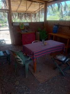 a table and a chair in a room with a table at Wasi Center Homestay in Máncora