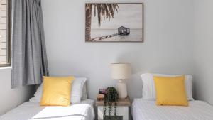 a living room with two beds and a table at Bangalee 2 at Sunrise in Soldiers Point