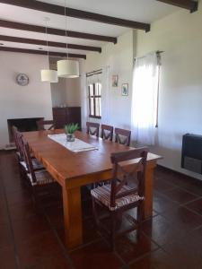 a dining room with a wooden table and chairs at La casita de Todd in Todd +12 photos