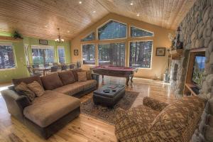 a living room with a couch and a pool table at COH1669 - Hawk's View Hideaway home in South Lake Tahoe