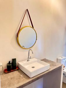 a bathroom with a white sink and a mirror at Casa Ingapura Suite Tainha - Povoado Bar da Hora 15 min de canoa para Atins - Estilo B&B - Café da Manhã Simples - Conforto in Atins