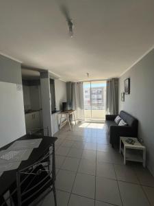 a living room with a couch and a table at Departamento equipado 307 Ovalle in Ovalle