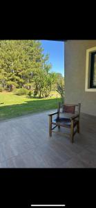 a bench sitting on a patio near a building at Casa rural in Rivera +1 photo