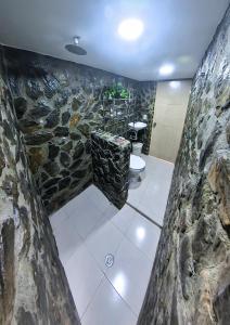 a stone bathroom with a toilet and a stone wall at CASA LOMA BEACH LOFT in Taganga +60 photos