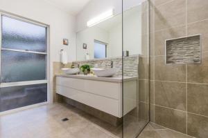 a bathroom with two sinks and a shower at Slipaway 1770 in Seventeen Seventy +41 photos