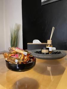 a table with a bowl of food and a plate of snacks at spacieux & lumineux 15min paris gare de lyon in Villeneuve-Saint-Georges +9 photos