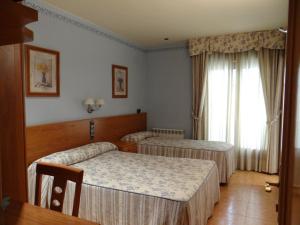 Cette chambre comprend 2 lits et une fenêtre. dans l'établissement Hotel Casa Carmen, à Benabarre