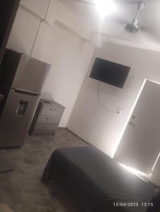 a bedroom with a bed and a light on the wall at Depa in Mazatlán +1 photo