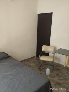 ein Schlafzimmer mit einem Bett, einem Schreibtisch und einem Stuhl in der Unterkunft Depa in Mazatlán + 1 Foto