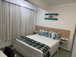 a hotel room with a bed and a window at Flats Linda Vista Para o Mar in Macaé