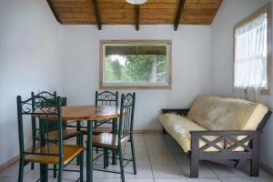 a living room with a table and a couch at Wenu Ruka in El Bolsón