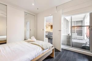 A bed or beds in a room at Coastal Getaway with Parking and Steps from the Beach