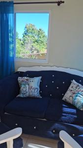 a blue couch in a living room with a window at Sweet Home in Monte Llano