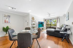 a living room with a table and a couch at Hawaiian Gardens 17 in Coffs Harbour