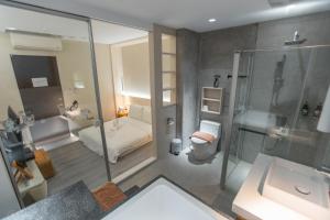 a bathroom with a shower and a toilet and a sink at Happiness . danshui in Tamsui +34 photos