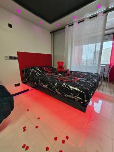 a bedroom with a bed with red roses on the floor at C12 Deluxe in Cap d'Agde