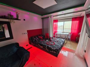 a room with a bed with red lights in it at C12 Deluxe in Cap d'Agde