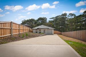 a driveway leading to a house with a fence at Gorgeous 4 Bedroom House - Blackmans Bay in Kingston Beach