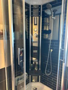 a bathroom with a shower with a glass door at Tetouan house vue- chambre climatisée in Tétouan