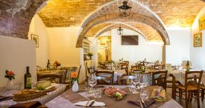 a restaurant with tables and chairs in a room at Tuscany - Romantic Getaway in Montecatini Val di Cecina +30 photos