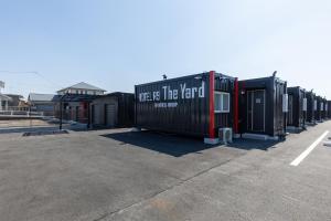 a row of shipping containers in a parking lot at HOTEL R9 The Yard Yabuki in Yabuki