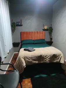 a bedroom with a bed and a chair in it at Recanto Arvoredo casa 3 quartos piscina garagem e NF para 12 hospedes in Concordia