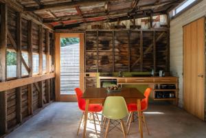 a kitchen with a table and orange chairs at Suite Shed, Unique accessible private guest suite in Launceston in Launceston
