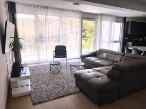 a living room with a couch and a chair at Hotel Valley of Business Frankfurt-Airport - GREY LABEL PENTHOUSE in Hofheim am Taunus
