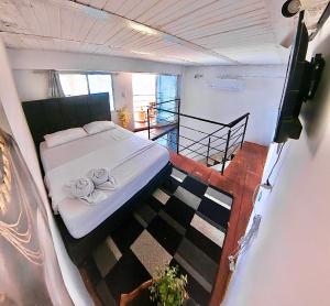 a bedroom with a bed with two towels on it at CASA LOMA BEACH LOFT in Taganga