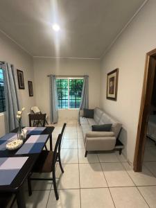 a living room with a table and a couch at Casa en Puero Cortes in Puerto Cortés