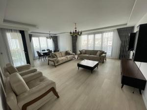 a large living room with couches and a table at Elezoğlu Apart Luxury Apartments with Sea and City View in Yomra +7 photos