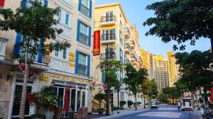 a street with tall buildings on a city street at Luxury Hotel & Spa Milan 38 Sunset Town Hotel Phu Quoc in Phú Quốc