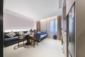 Posezení v ubytování Shanghai Xujiahui Grow Suisse Place Apartment Hotel + 10 fotografií
