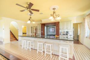 a kitchen with a large island with bar stools at 6B Luxury Rustic Farm Manor In Lang Lang in Lang Lang