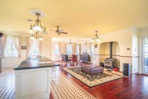 a living room with a kitchen and a living room with a fireplace at 6B Luxury Rustic Farm Manor In Lang Lang in Lang Lang