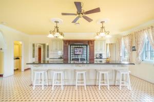 a kitchen with a large island with bar stools at 6B Luxury Rustic Farm Manor In Lang Lang in Lang Lang