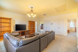 a large living room with a couch and a flat screen tv at 6B Luxury Rustic Farm Manor In Lang Lang in Lang Lang