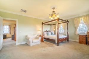 a bedroom with a canopy bed and a chair at 6B Luxury Rustic Farm Manor In Lang Lang in Lang Lang +37 photos