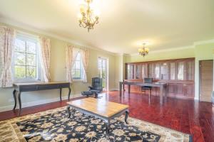 a living room with a table and a piano at 6B Luxury Rustic Farm Manor In Lang Lang in Lang Lang